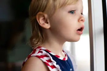 A child looking outside, curiously